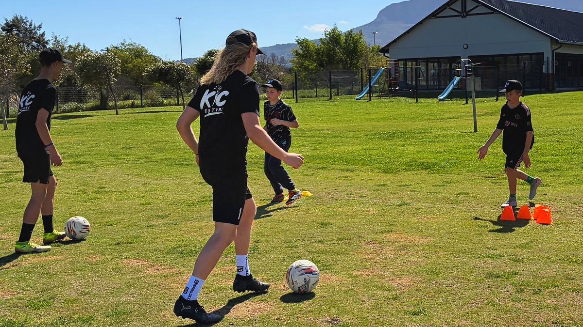 Jack and Connor running a small group drill on a sunny field, players working the ball between cones.